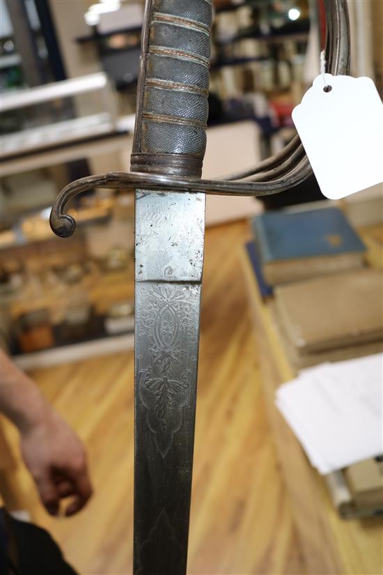 A Victorian sabre with etched blade and a mid 19th century sabre, both with scabbards